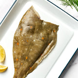 A portion of Plaice fillet skin side up from Rockfish Online Seafood Market on a baking tray