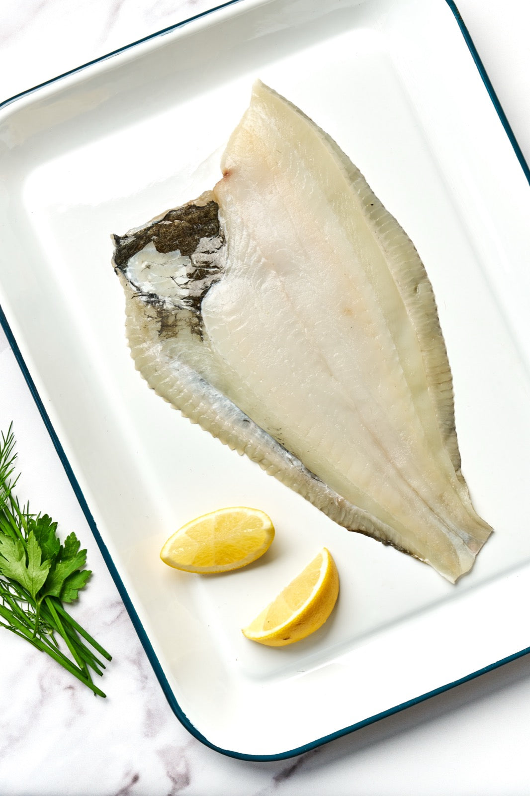 A portion of Plaice fillet from Rockfish Online Seafood Market on a baking tray
