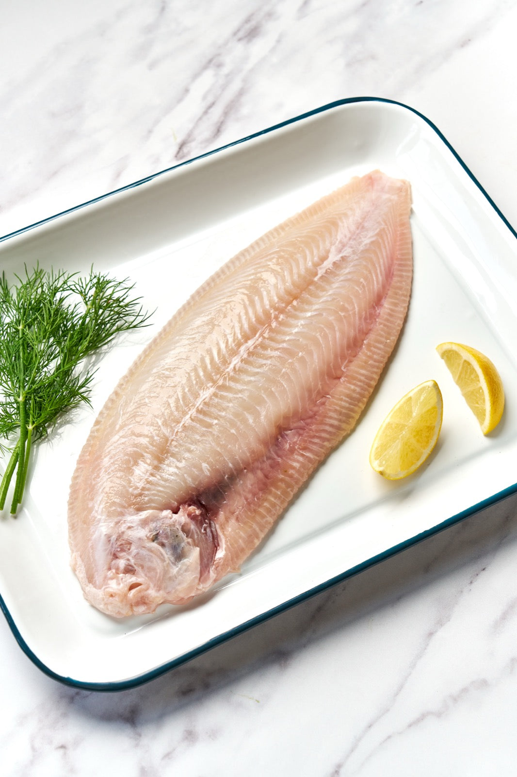 A portion of sand sole from Rockfish Online Seafood Market on a baking tray