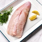 A portion of whole Monkfish tail from Rockfish Online Seafood Market on a baking tray