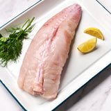 A portion of whole Monkfish tail from Rockfish Online Seafood Market on a baking tray