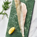 A portion of Grunard fillet from Rockfish Online Seafood Market on a piece of marble