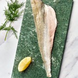 A portion of Grunard fillet from Rockfish Online Seafood Market on a piece of marble