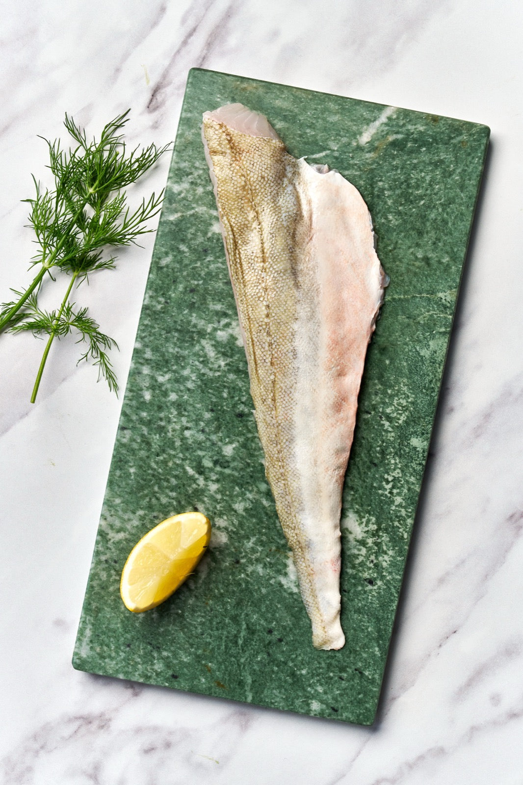 A portion of Grunard fillet from Rockfish Online Seafood Market on a piece of marble