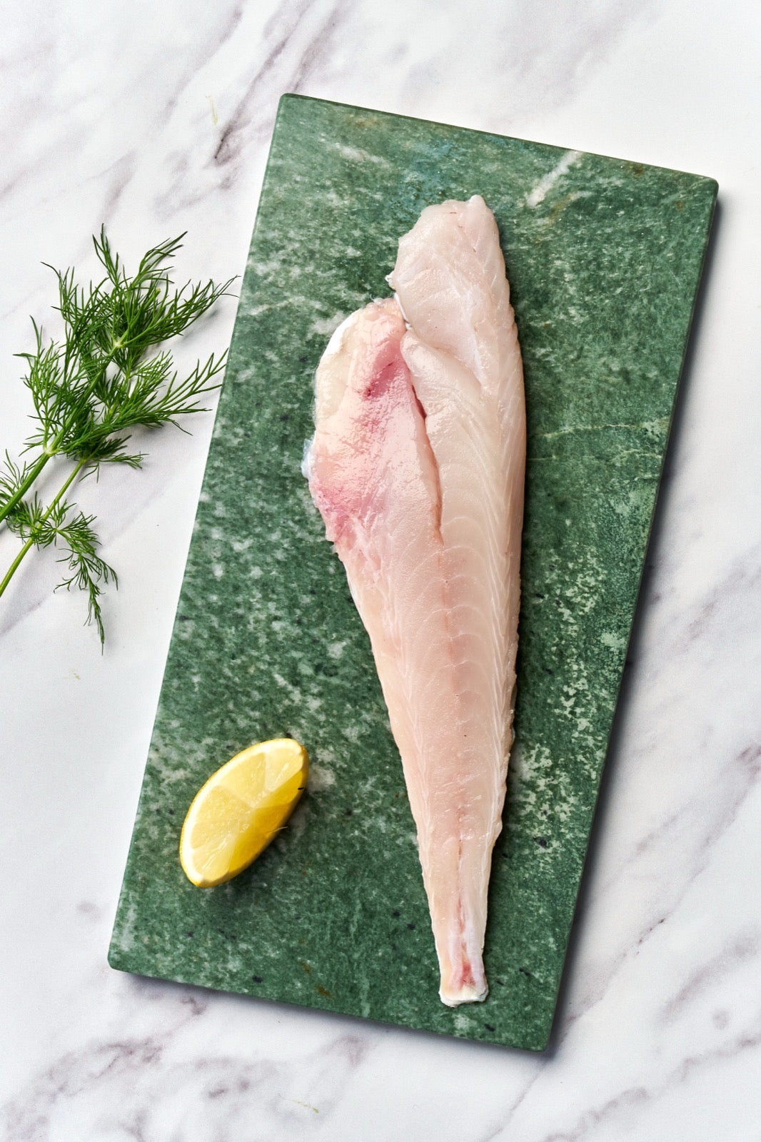 A portion of gurnard fillet from Rockfish Online Seafood Market on a piece of marble