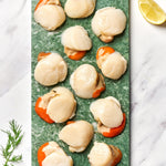 A portion of scallop meat from Rockfish Online Seafood Market on a piece of marble