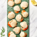 A portion of scallop meat from Rockfish Online Seafood Market on a piece of marble