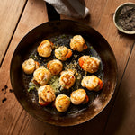 A portion of scallops from Rockfish Online Seafood Market cooked in a frying pan