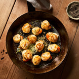 A portion of scallops from Rockfish Online Seafood Market cooked in a frying pan