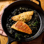 A portion of Red Mullet fillets from Rockfish Online Seafood Market cooked in cast iron skillet in butter and rosemary.