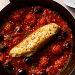 A portion of Monkfish fillet from Rockfish Online Seafood Market cooked in a pan with a rich tomato sauce around it