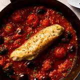 A portion of Monkfish fillet from Rockfish Online Seafood Market cooked in a pan with a rich tomato sauce around it