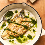 A portion of Plaice from Rockfish Online Seafood Market cooked in a pan drizzled in a salsa verde