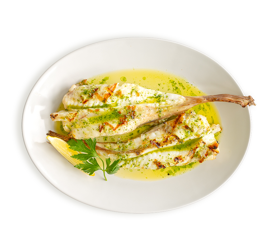 Two monkfish tails served with garlic butter and a wedge of lemon at Rockfish restaurants
