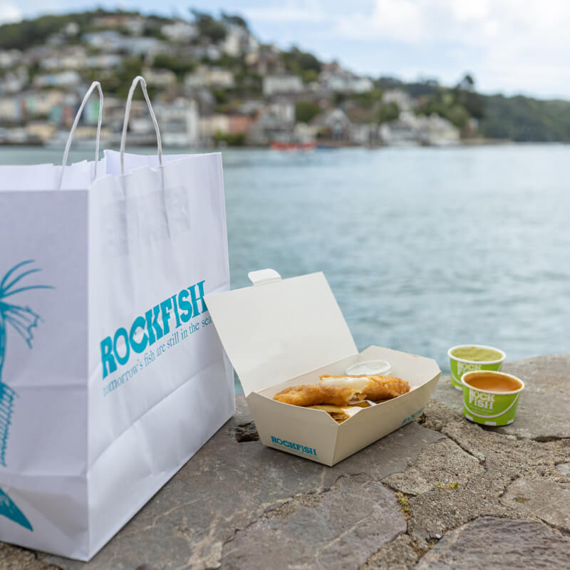 Rockfish takeaway fish & chips with a side of curry sauce & mushy peas. All in recyclable packaging