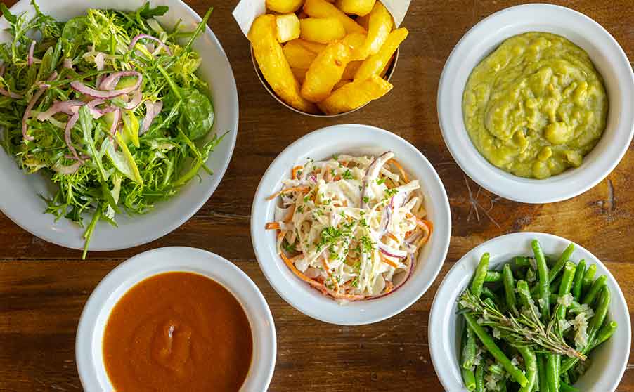 A selection of sides available at Rockfish including, curry sauce, garlic slaw, mushy peas, green beens and chips