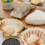 Valentine box from Rockfish laid out with caviar at the front surrounded by disco scallops and prime turbot fillets and a jar of garlic butter.